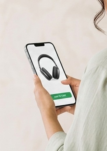 A shopper viewing headphones on a mobile phone